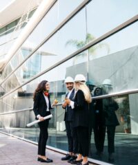 architects-wearing-helmets-front-glass-building_23-2147702495